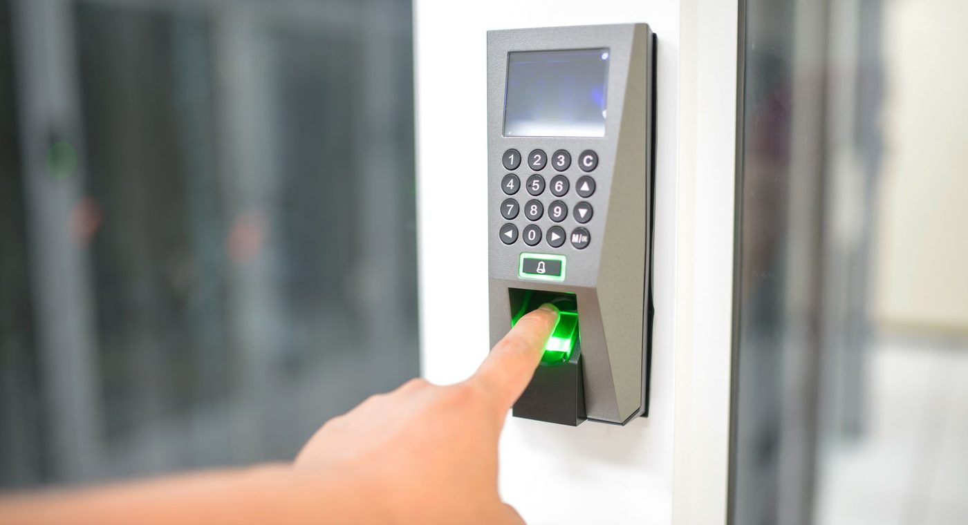 A keypad reader beside an office door