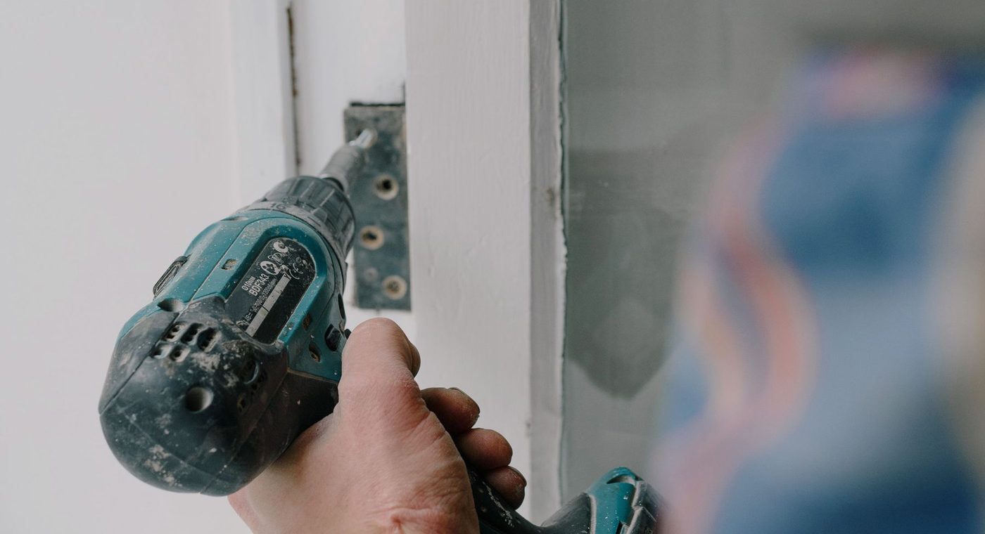 Checking the strike and latch alignment on a sagging commercial door