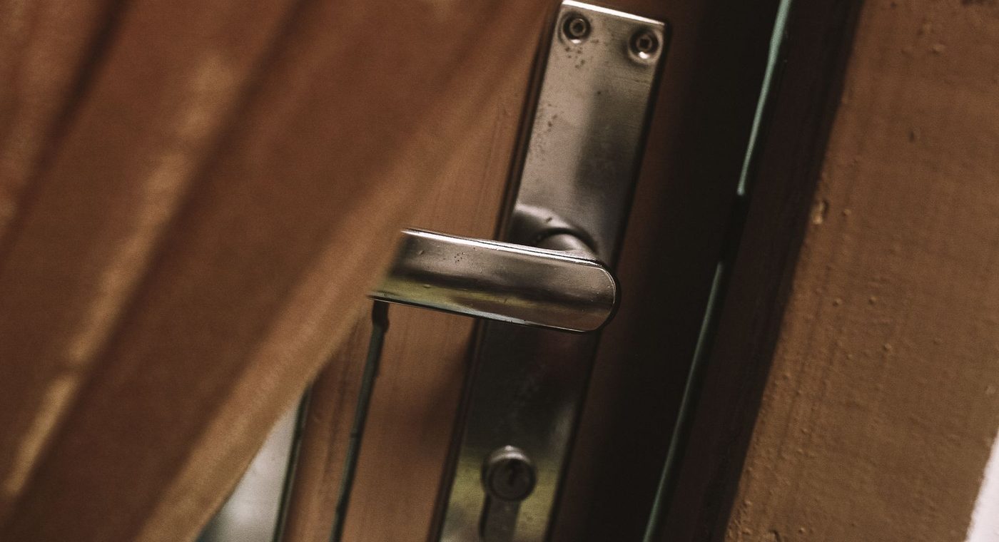 A commercial lever lock and deadbolt on a steel office door