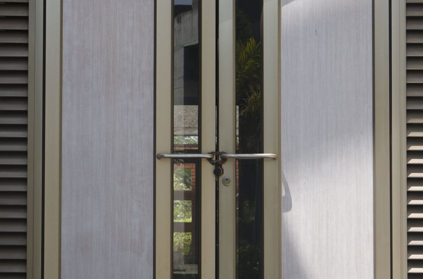 Metal-framed glass double doors into an office building